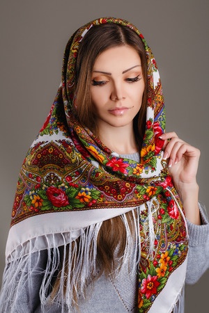 30138812 - beautiful oriental look portrait of a beautiful young woman with a scarf on her head russian beauty russian national traditional scarf on head